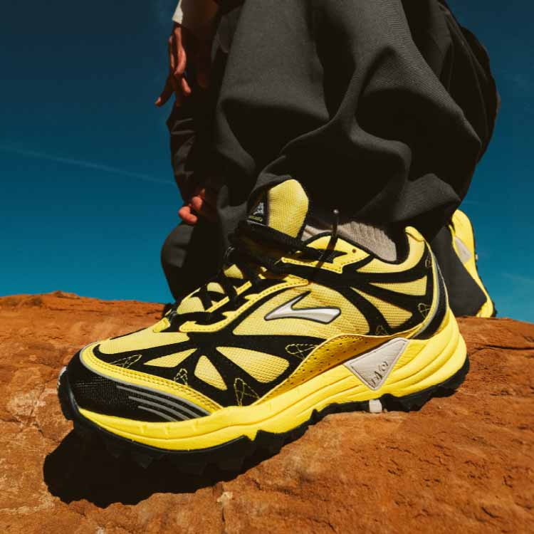 A collage of a person standing against a blue background, and an image of bright Brooks shoes.
